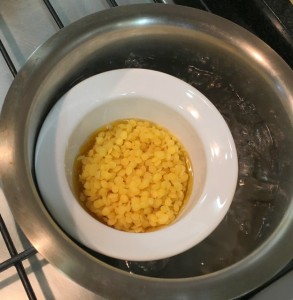 Melting natural beeswax on the gas in a double-broil process